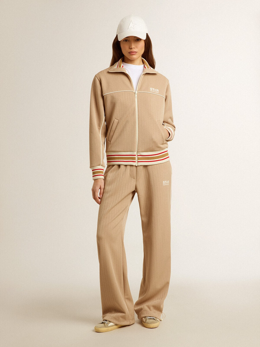 ljusbeige joggingbyxor med vit logotyp för dam