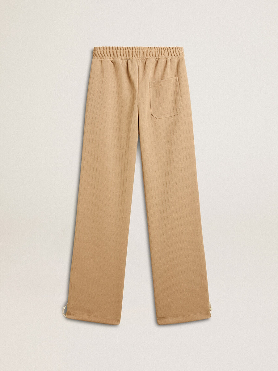 ljusbeige joggingbyxor med vit logotyp för dam