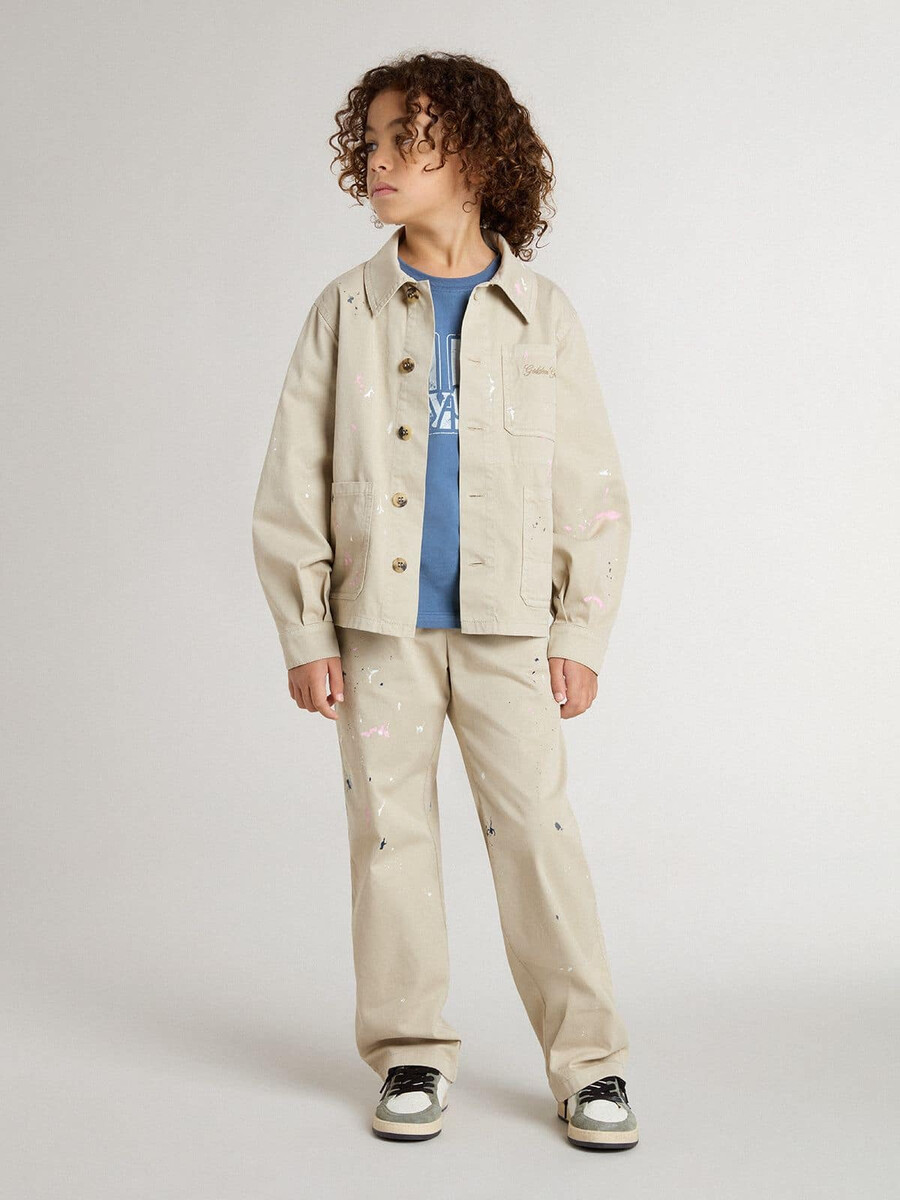 beige barnjacka med flerfärgade stänk